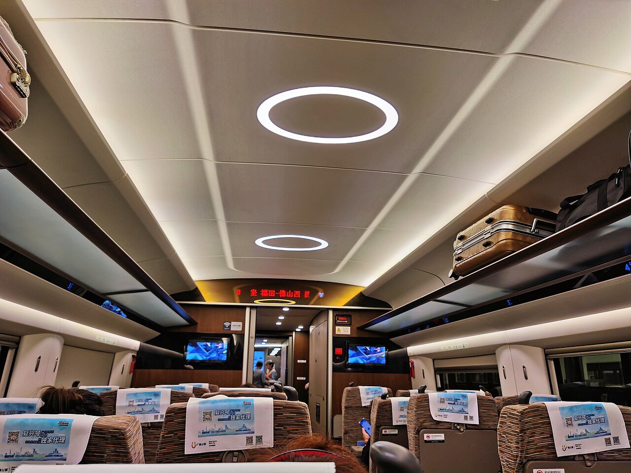 Second-, first-, and business-class seating on a Chinese high-speed train.
