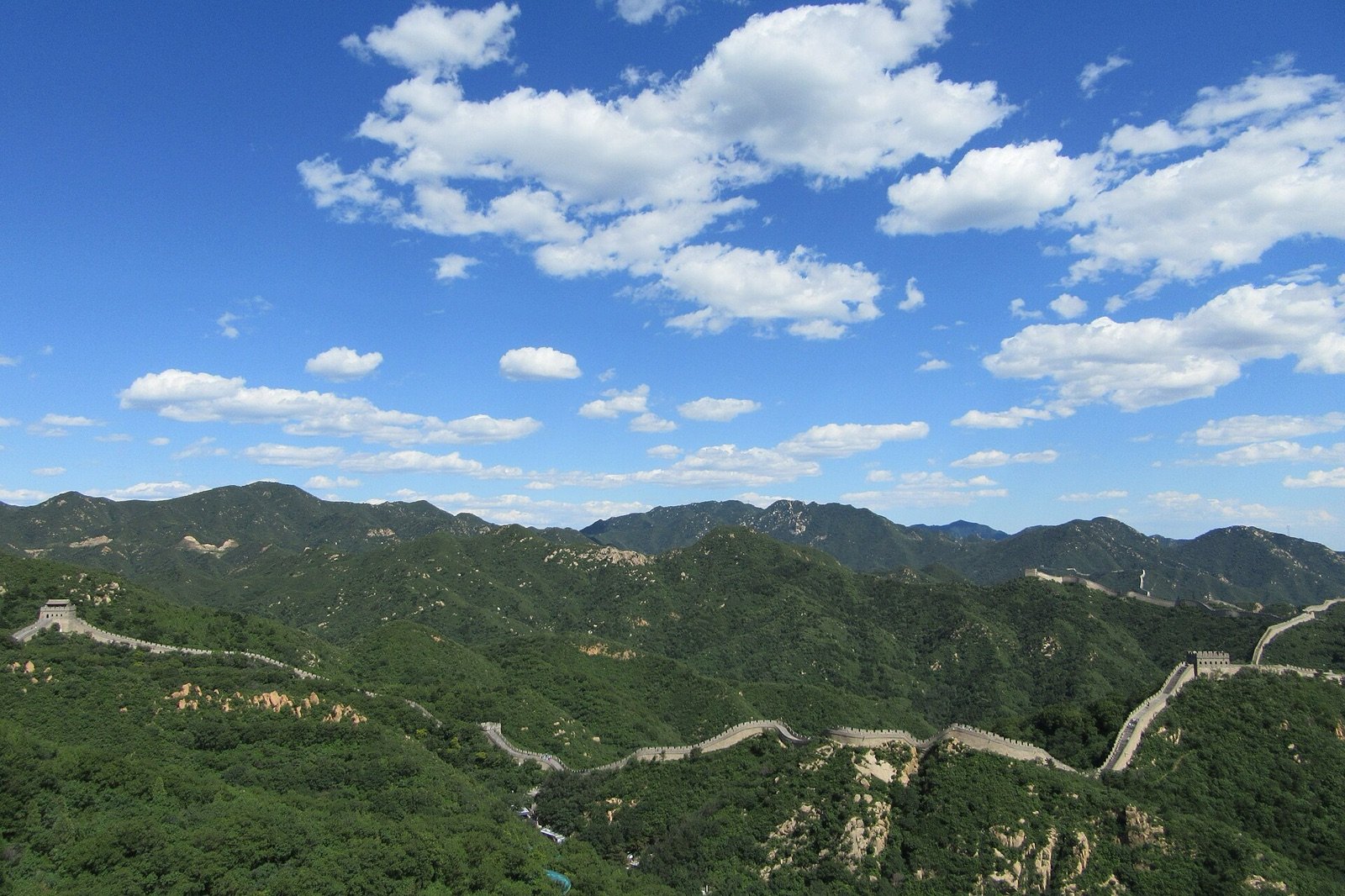 Badaling Great Wall winding across green mountains under a clear blue sky