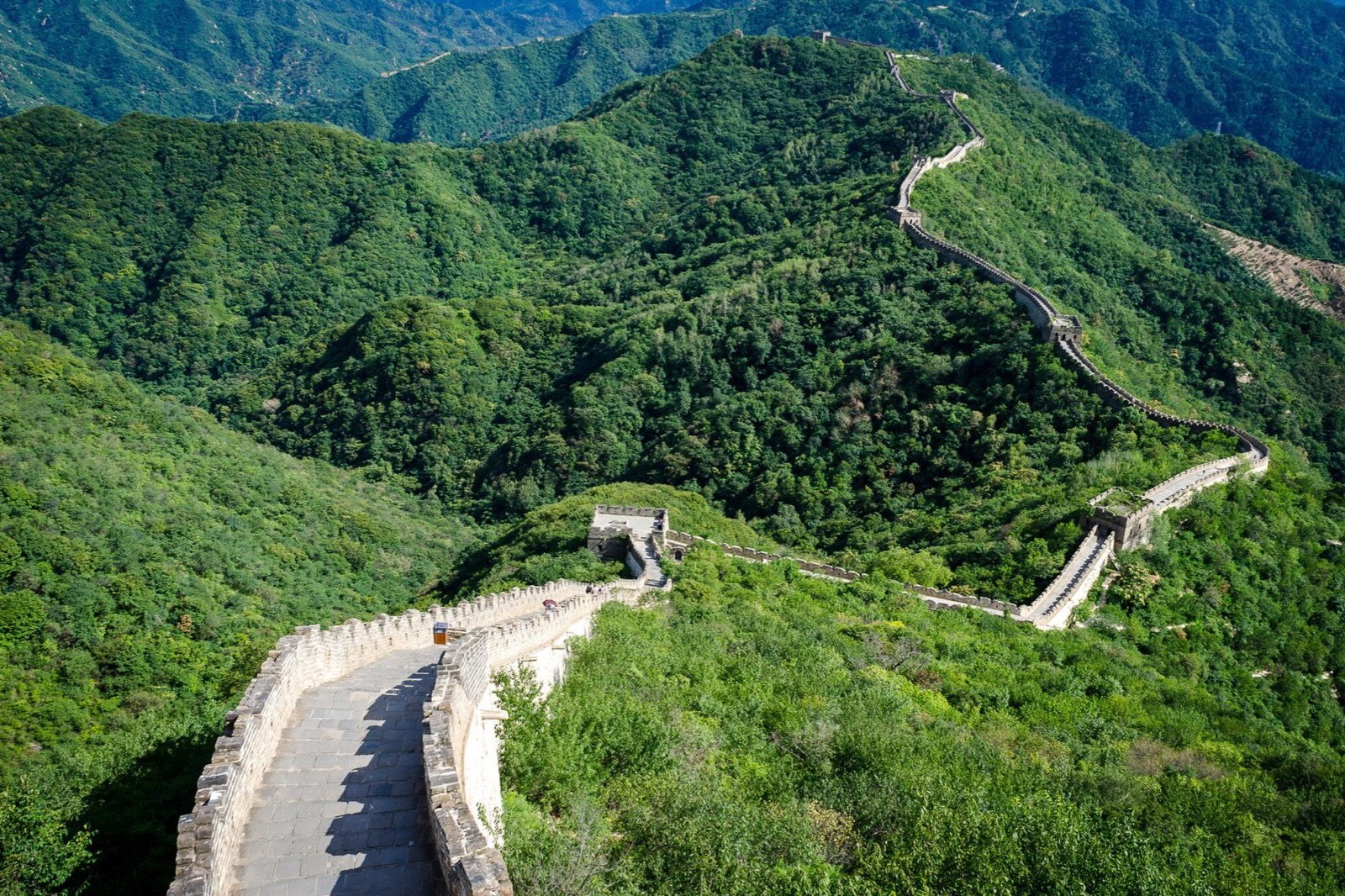 Great Wall winding across green mountains at Mutianyu near Beijing.