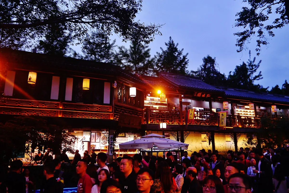 Crowds beneath lantern-lit shops at Jinli Ancient Street in Chengdu