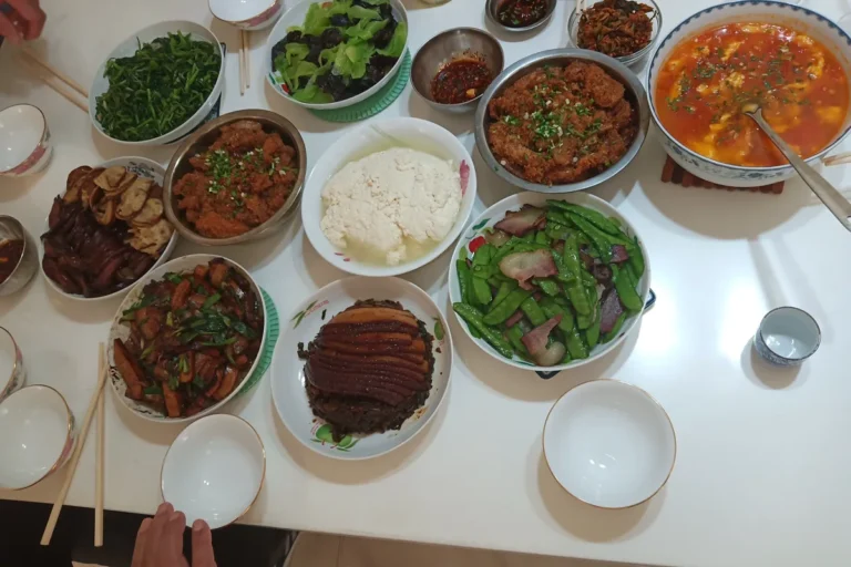 Chongqing family dinner table with multiple cooked dishes