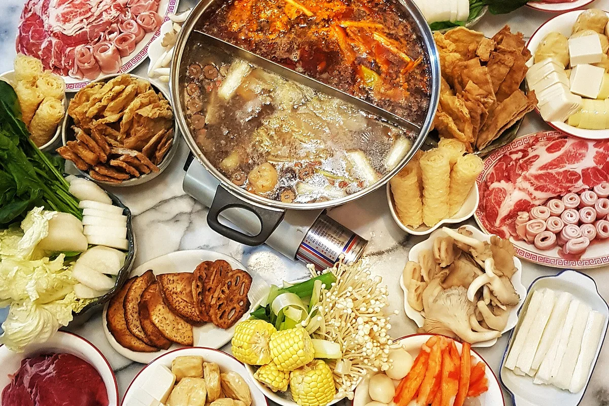 Home-style Chongqing hot pot surrounded by vegetables, meat and tofu