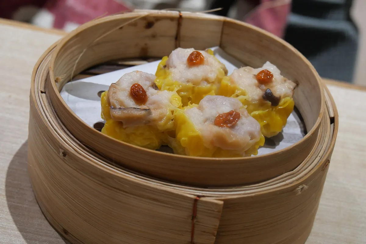 Yellow siu mai dumpling served at a dim sum restaurant