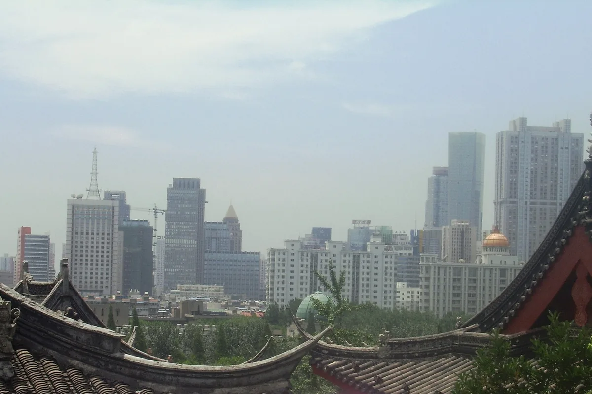 Nanjing skyline beyond traditional roofs at Jiming Temple