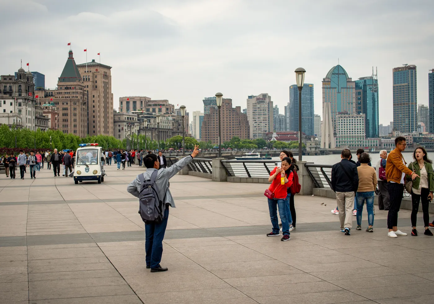 Visitors walking along the Bund promenade in Shanghai