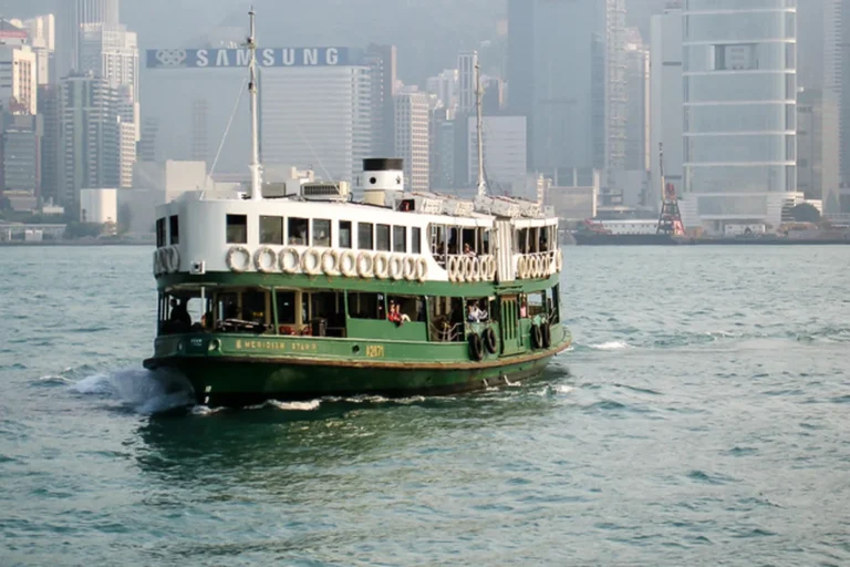 Green-and-white Star Ferry crossing Victoria Harbour in Hong Kong