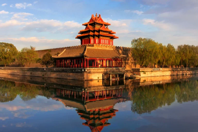 Forbidden City corner tower reflected in the moat during spring