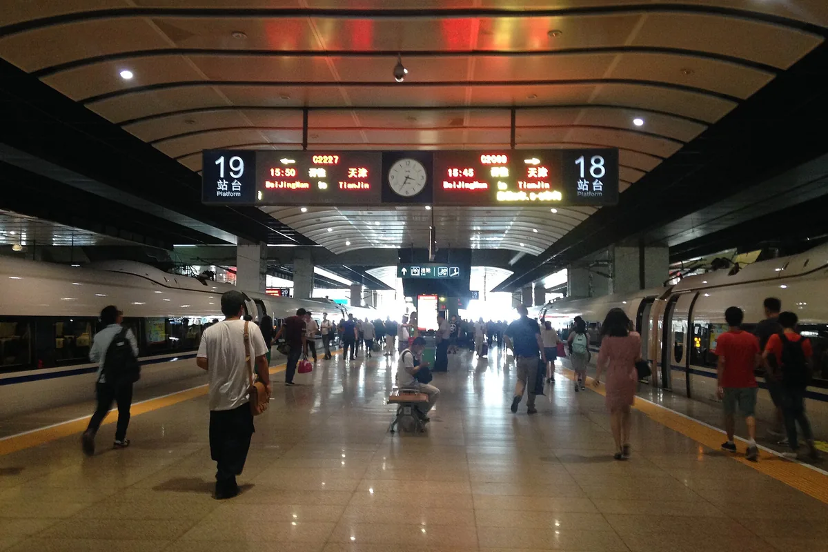 Busy platform and departure signs at Beijing South Railway Station