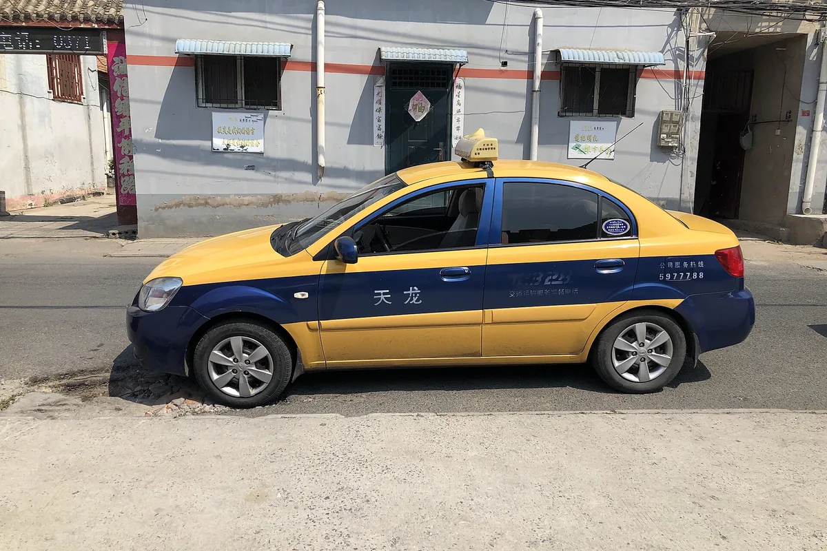 Licensed yellow-and-blue city taxi in Kaifeng, China