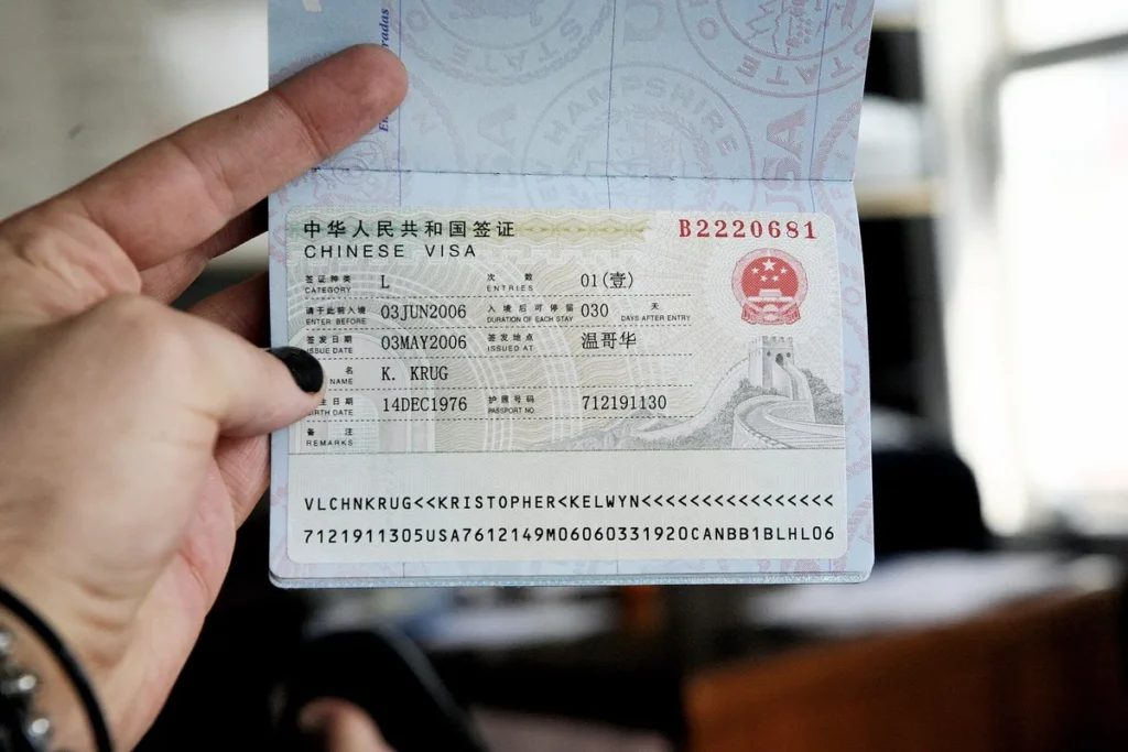 PRC tourist visa sticker in a United States passport