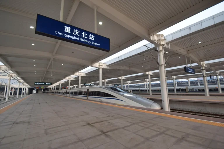 Chongqing North station sign above a high-speed train platform