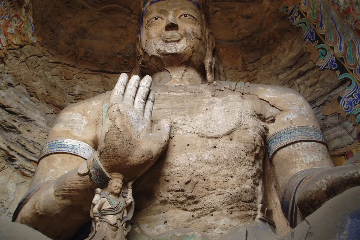 Close view of a painted Buddha inside a Yungang cave