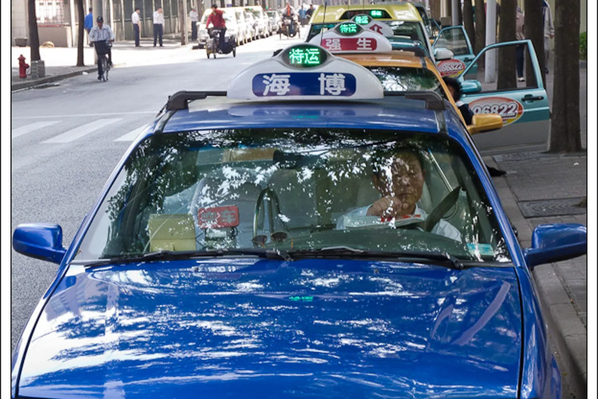 Blue taxi on a street in Shanghai