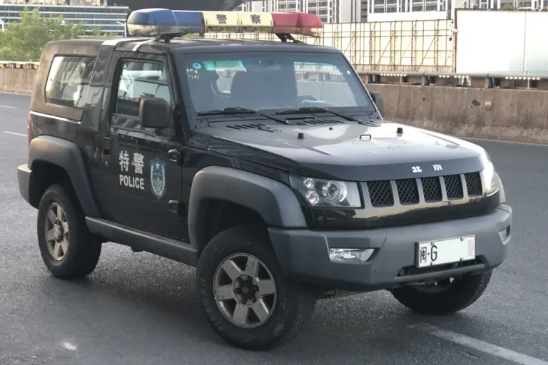 Mainland China police vehicle with a red-and-blue emergency light bar in Fujian