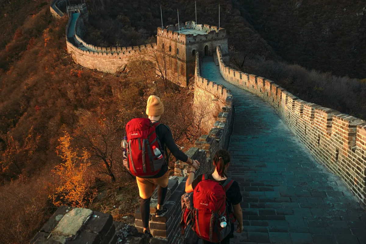 Two hikers walking along the Great Wall of China