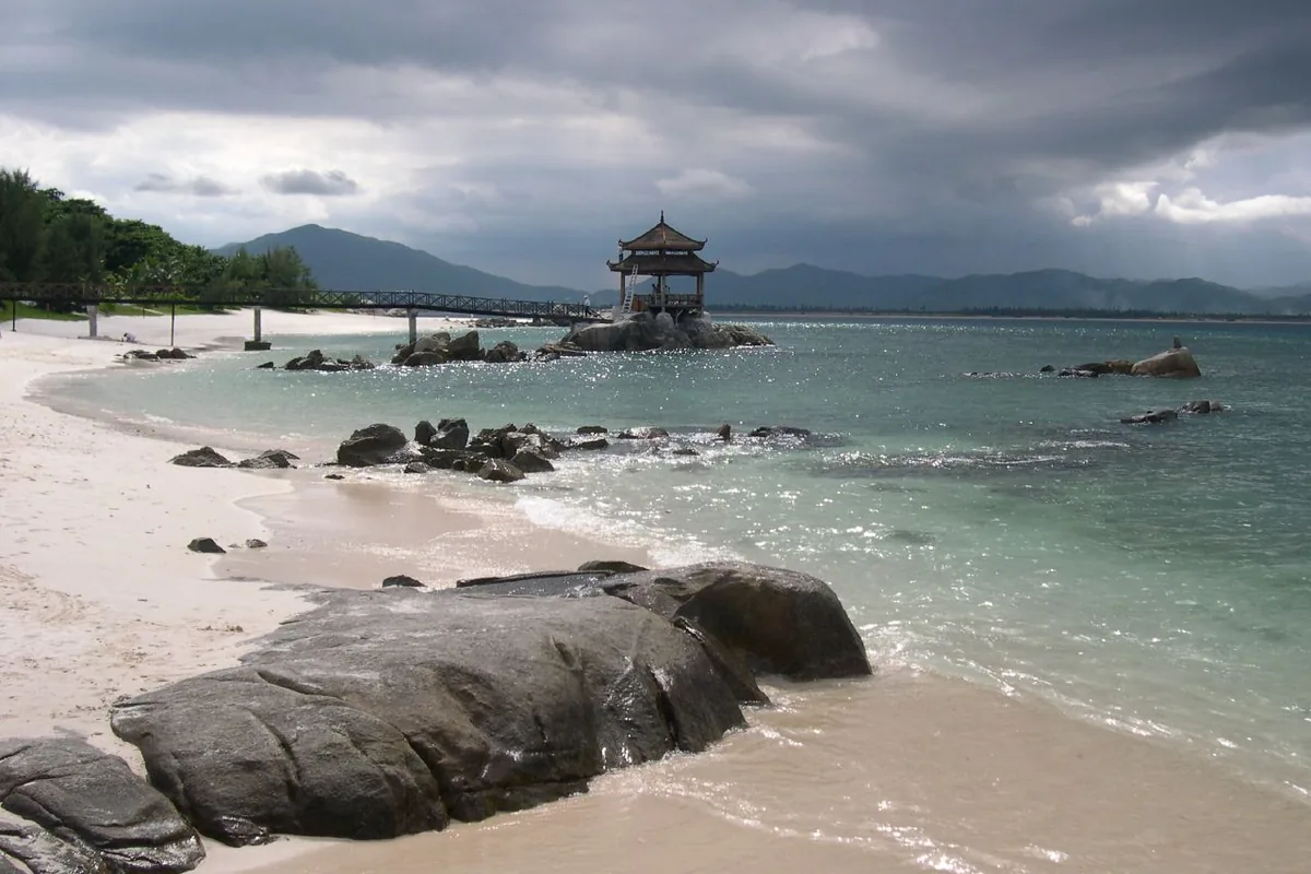 Rocky tropical beach and pavilion on Wuzhizhou Island near Sanya