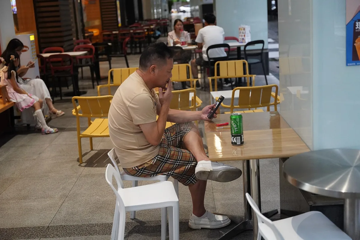Person watching short-form video on a smartphone in Shenzhen