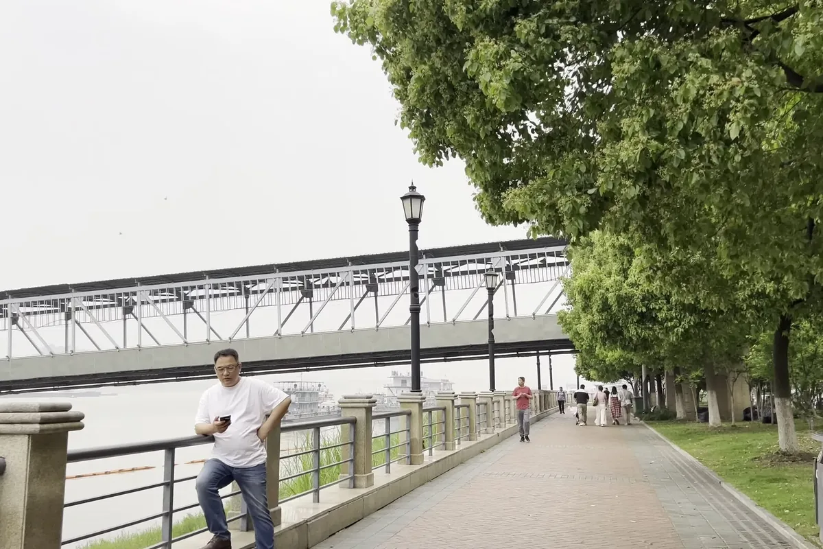 People walking beside the Yangtze River in Wuhan