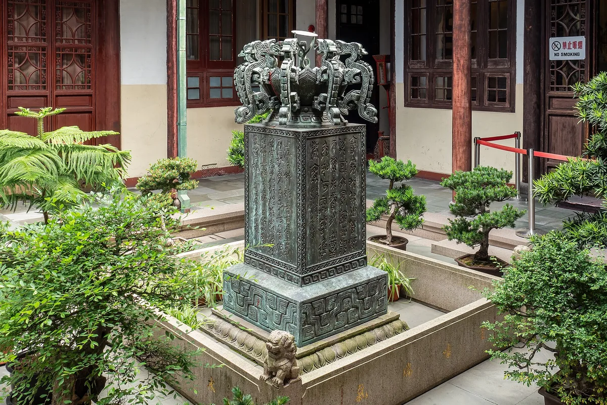 Bronze fountain and temple buildings in a Jade Buddha Temple courtyard