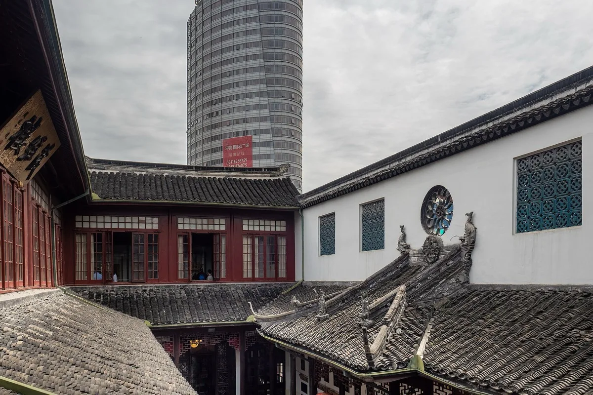 Tiled temple roofs and a modern tower at Shanghai Jade Buddha Temple