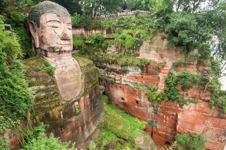 Leshan Giant Buddha carved into a red sandstone cliff