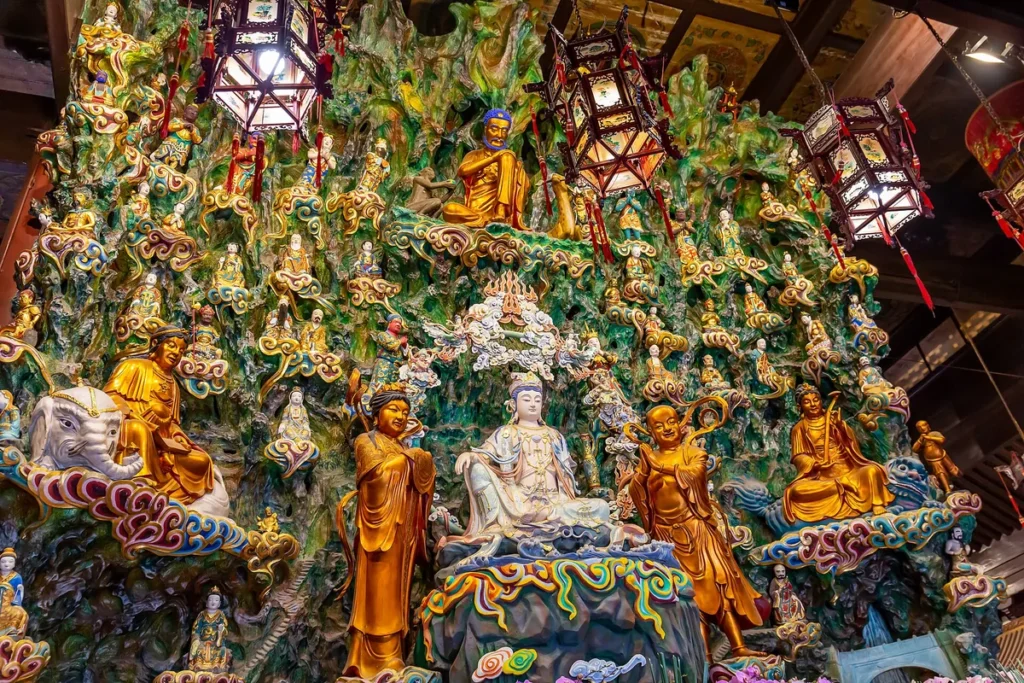 Buddhist figures on a colourful wall inside Longhua Temple in Shanghai