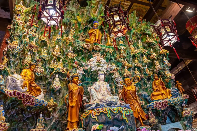 Buddhist figures on a colourful wall inside Longhua Temple in Shanghai