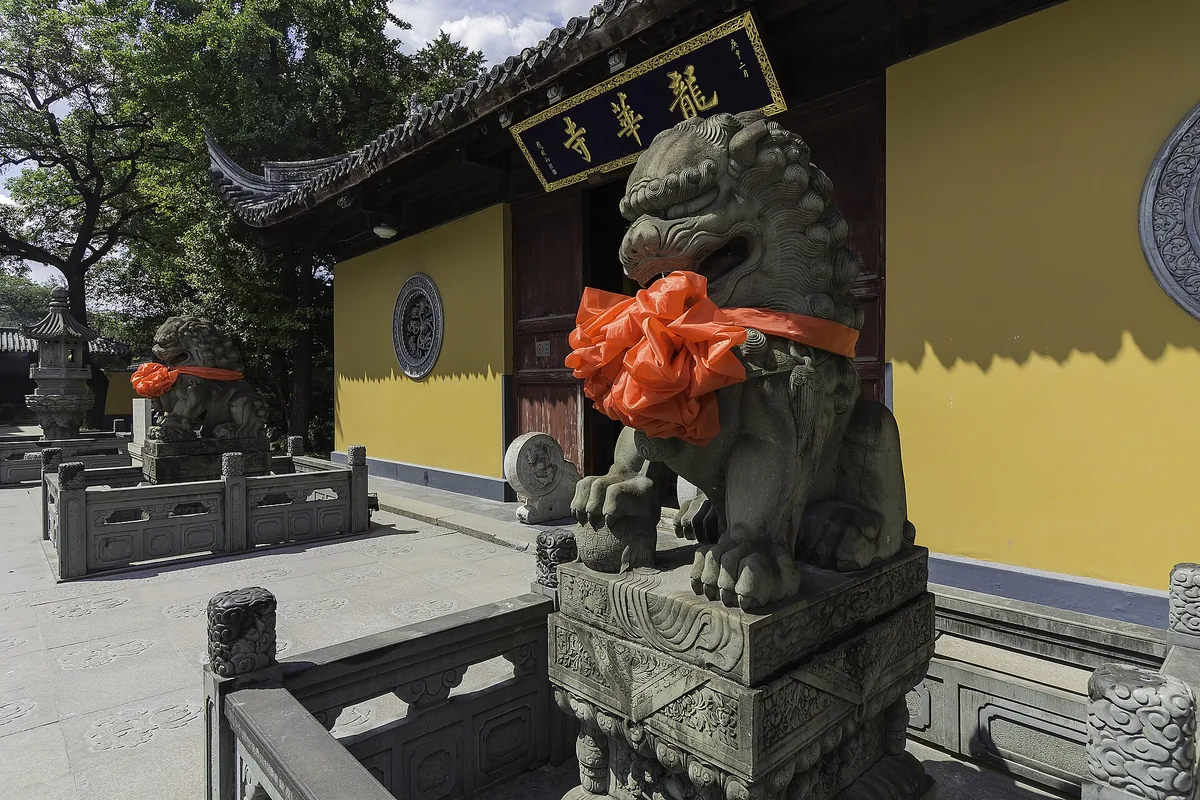 Stone guardian lions outside a hall at Longhua Temple in Shanghai