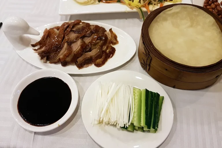 Whole Peking duck served with pancakes and garnishes