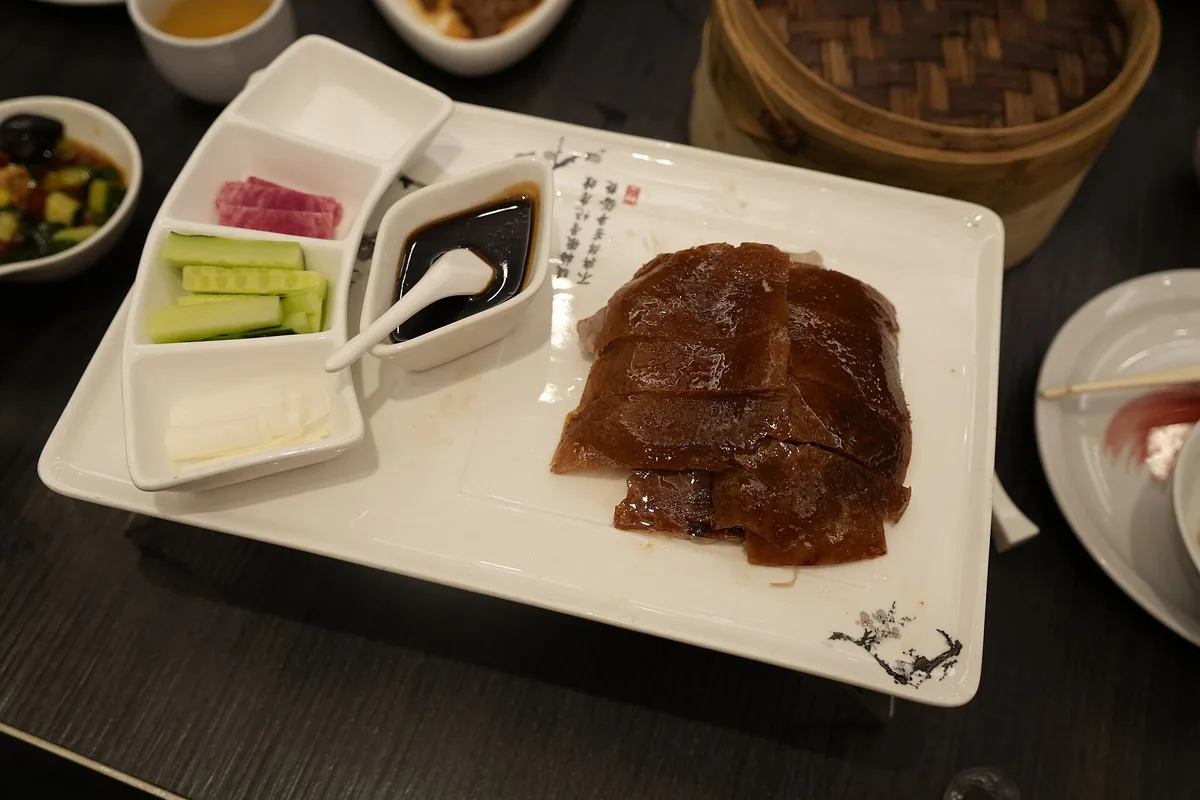 Sliced Beijing roast duck arranged with side dishes