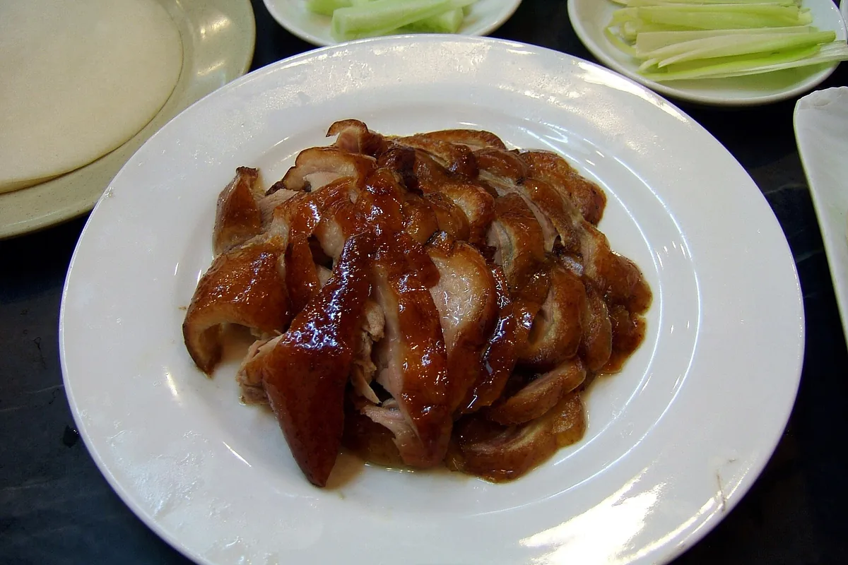 Carved Peking duck presented on a restaurant plate in Beijing