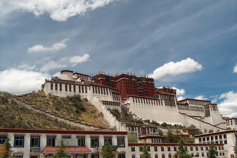 Potala Palace rising above Lhasa against a clear blue sky