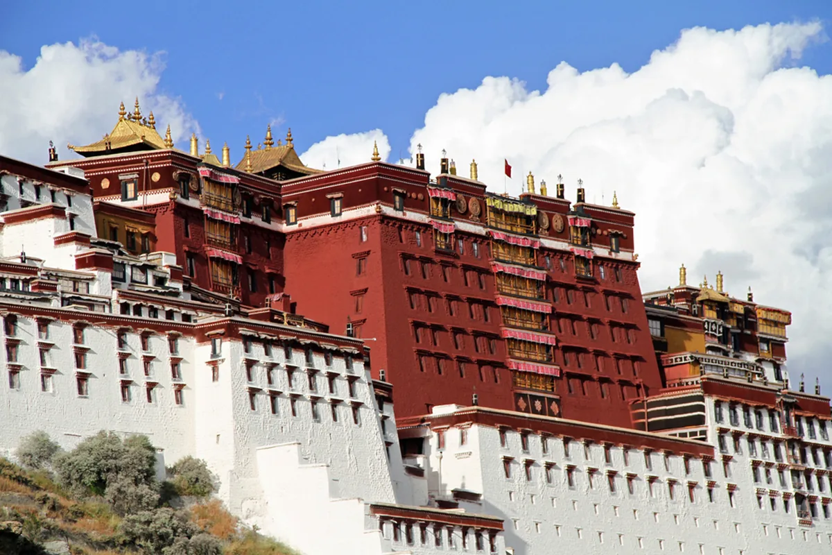 Red and white palace buildings on Potala Palace hill in Lhasa