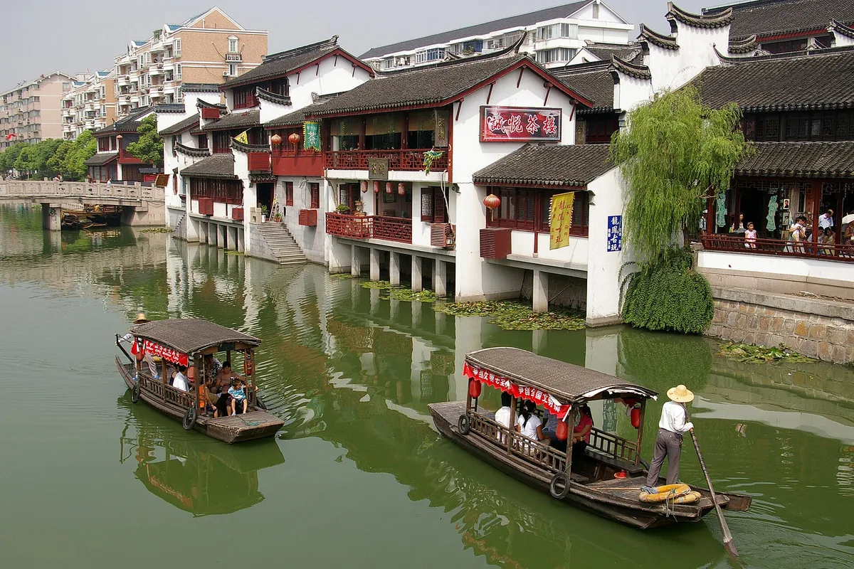 Traditional canal-side buildings and sightseeing boats in Qibao, Shanghai