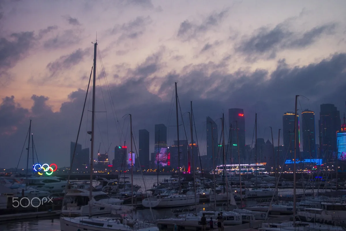 Qingdao marina and waterfront skyline at dusk