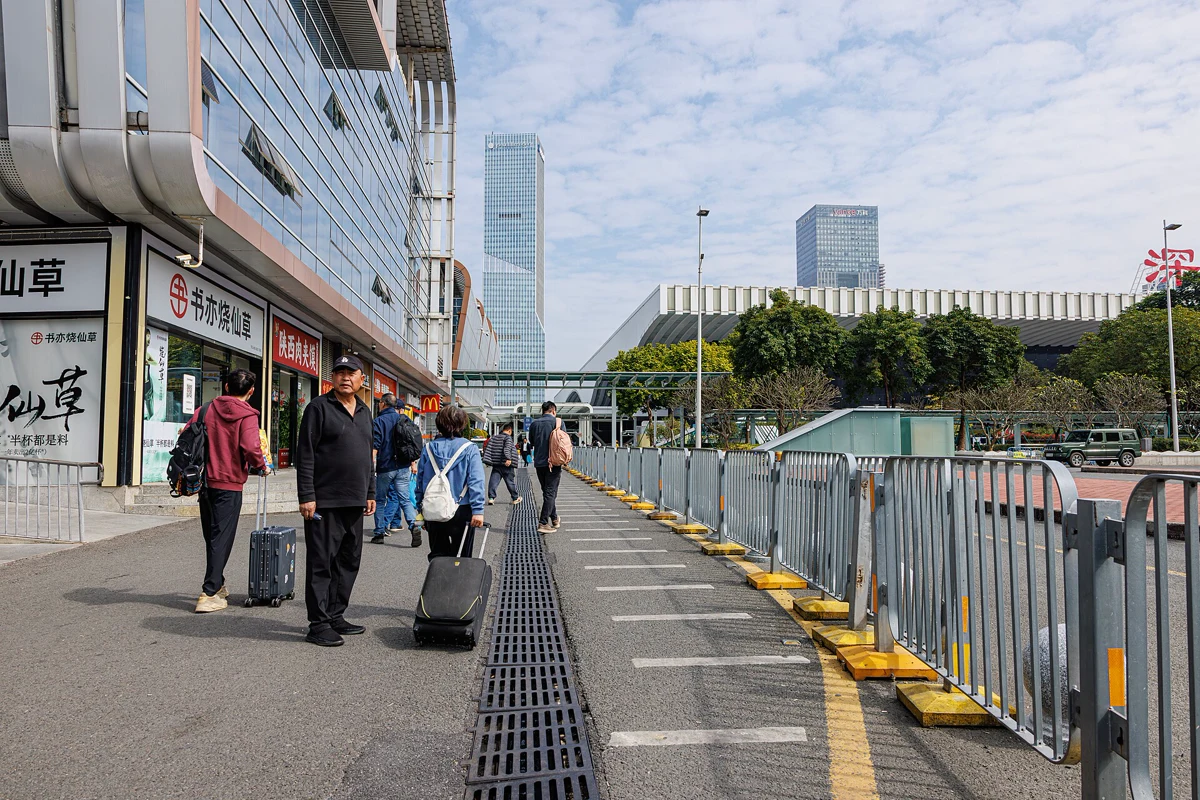 Travellers walking beside Shenzhen North Railway Station