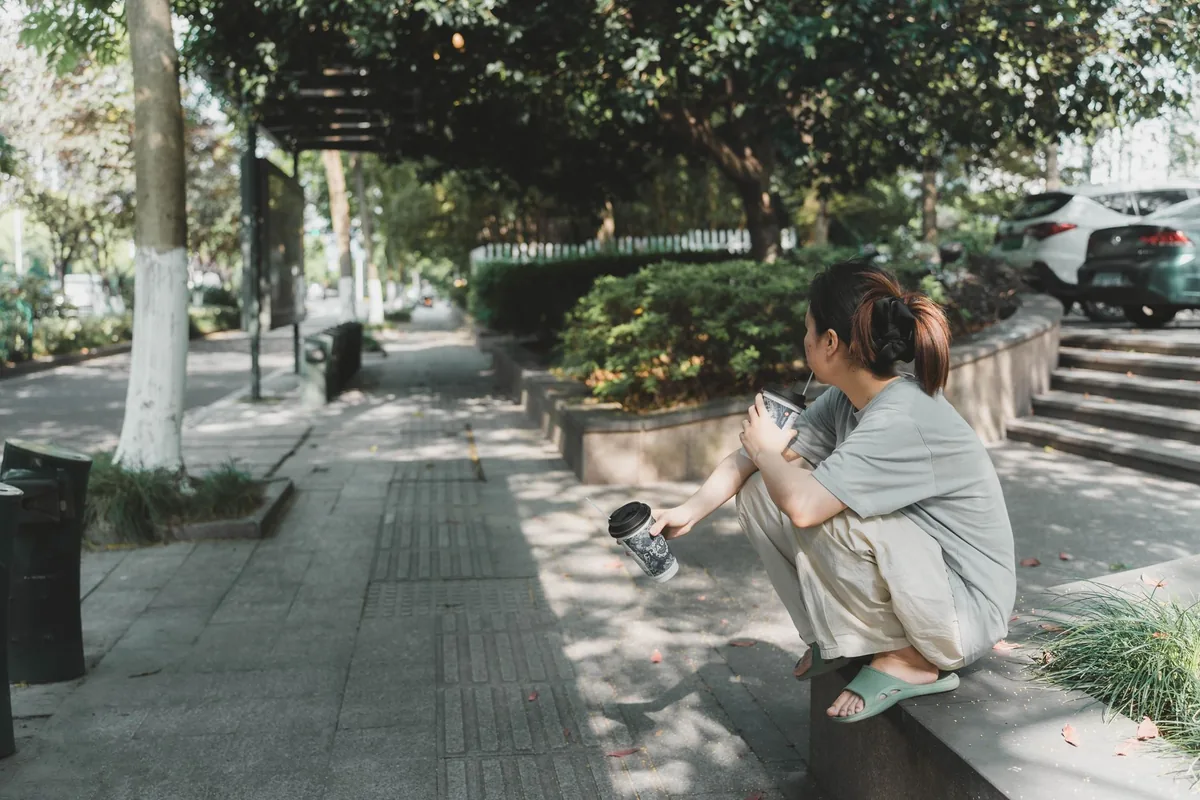 Woman taking a break during a city walk in Hangzhou