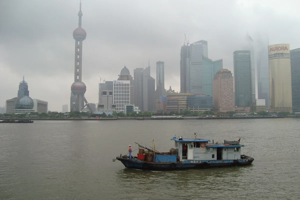 Pudong skyline seen through rain and low cloud across the Huangpu River